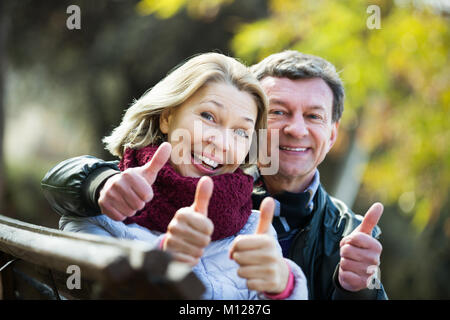 Portrait of positive elderly couple spending time outdoors and enjoying together Stock Photo