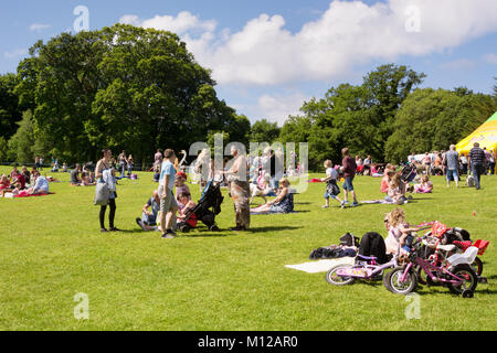 Many people, families with children enjoying a warm sunny day on the lawns of the Calzean estate, Scotland Stock Photo