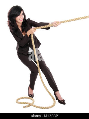 Business competition. Young business woman pulling a rope isolated on white background Stock Photo