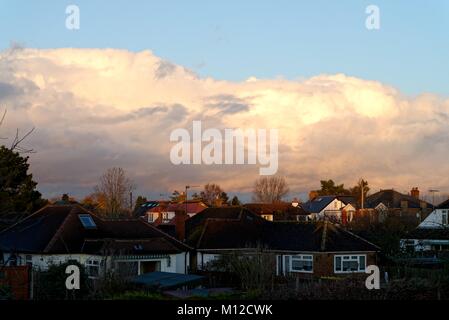 Dramatic winter clouds over suburban landscape at sunset Stock Photo