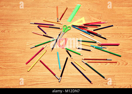 Scattered on the floor chaotically colored pencils, scissors and measuring . Stock Photo