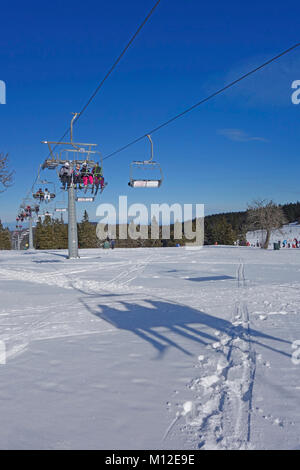 People riding the chair lift. Rogla ski resort, Pohorje, Slovenia. Stock Photo