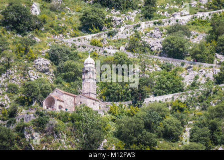 Church of Our Lady of Remedy and ancient fortress walls on the slope of Saint John mountain above Old Town of Kotor town in Bay of Kotor, Montenegro Stock Photo