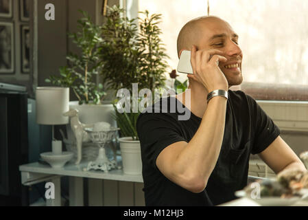 Young man having a cheerful phone call Stock Photo