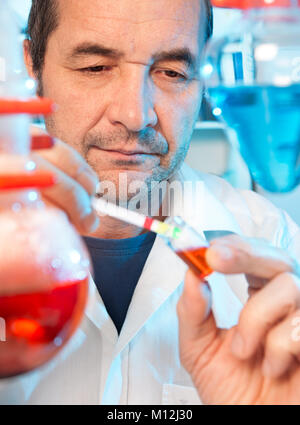 Senior scientist works in chemical laboratory Stock Photo