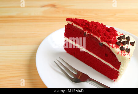 Red Velvet Shortcake with Cream Cheese Frosting on White Plate Served on Wooden Table Stock Photo