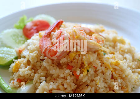 Closed up Thai style shrimp fried rice served on white plate with selective focus and blurred background Stock Photo