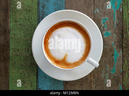 Close up white coffee cup with heart shape latte art on wood table at cafe  - Shamrock Foods