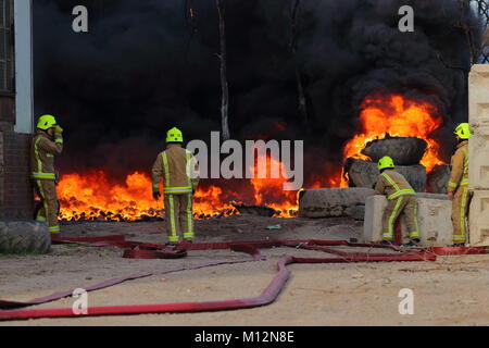 Firefighters wait for a water supply so that they can begin to tackle a fire in Beeston,Leeds,West Yorkshire Stock Photo