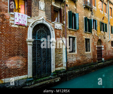 Waterway in venice with wrought ironwork on door Stock Photo