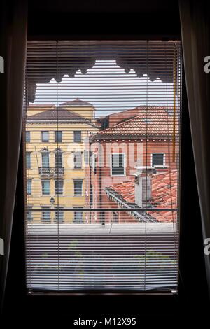 VENICE, ITALY - MAY 20, 2017: Beautiful picturesque buildings viewed from a window in Venice, Italy. Stock Photo