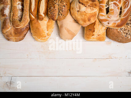 Different kinds of bread   on white wooden table Stock Photo