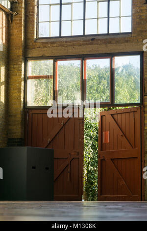 Doors from an old redecorated light factory building with light trails. Stock Photo
