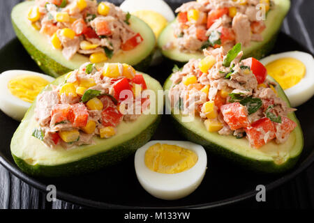 Delicious snack of avocado stuffed with tuna salad closeup on a plate. horizontal Stock Photo