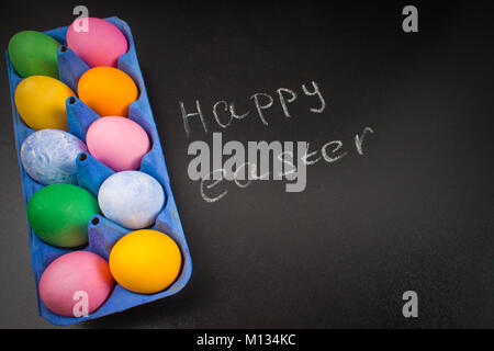 Chalk chalkboard Happy easter on a chalkboard and colorful eggs Stock Photo