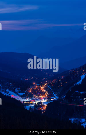 The ski resort town of Meribel and the 3 Valleys mountain area at dusk, France Stock Photo