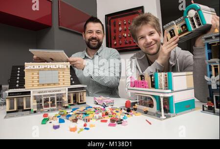 Berlin, Germany. 24th Jan, 2018. Lego enthusiasts Stephan Birner (L) and Felix Fleischer display their models in Berlin, Germany, 24 January 2018. The living room of Stephan Bierner in the district of Charlottenburg in Berlin looks like a Lego exhibition. Together with his partner Matthias Kornmaier they collect 40 year old pieces of all kinds. Credit: Jörg Carstensen/dpa/Alamy Live News Credit: dpa picture alliance/Alamy Live News Stock Photo