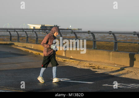 Elderly athletes at Southport, Merseyside, UK.  26th January. UK Weather.  Bright, sunny cold, start to the day as local residents take exercise, jogging, trotting or running at a slow or leisurely pace, along the seafront promenade. The main intention is to increase physical fitness and enjoy the sunshine, with albeit low temperatures. Credit: MediaWorldImages/AlamyLiveNews. Stock Photo
