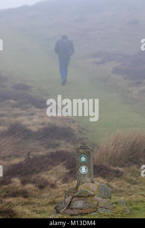 Flintshire, Wales, UK 26th January 2018, UK Weather:  A calm but foggy day in Flintshire and many parts of the UK. A walkers along the Offa’s Dyke Path in the Clwydian Range in the fog near to the summit of Penycloddiau an Iron Ages hillfort in the range Credit:  DGDImages/Alamy Live News Stock Photo