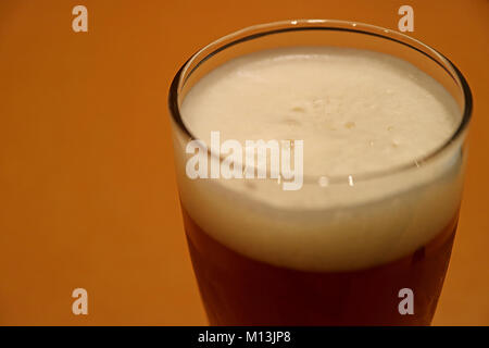 Closed up a Glass of Cold German Wheat Beer in the Room Light with Selective Focus and Copy Space Stock Photo