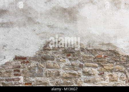 Old bricks with partial white plastered wall texture Stock Photo