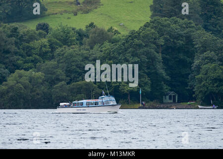 Passengers sailing on board Coniston Launch boat, use ferry service or enjoy lake cruise trip on Coniston Water - Lake District, Cumbria, England, UK. Stock Photo