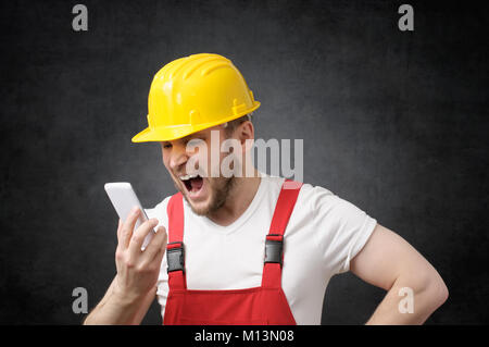 Construction worker shouting on the phone Stock Photo