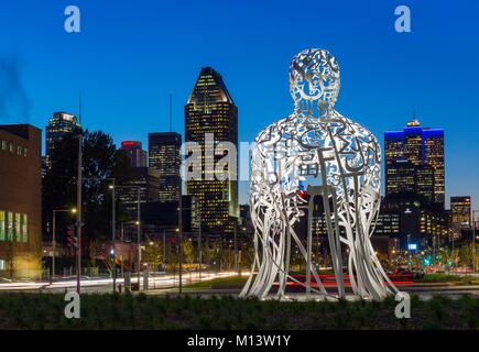 Canada, Province of Quebec, Montreal, the new Robert Bourrassa Boulevard, the sculpture named Source by the Spanish artist Jaume Plensa representation of the diversity of Montrealers, 10 meters high, night view with downtown skyscrapers Stock Photo