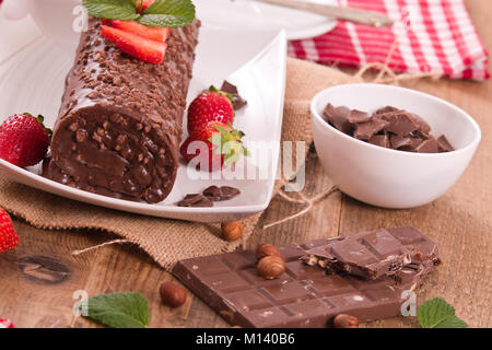 Chocolate roll with hazelnuts and strawberries. Stock Photo