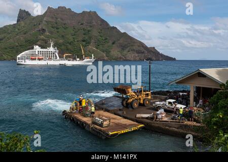 France, French Polynesia, Marquesas Archipelago, Hiva Oa Island, Puamau, cruise aboard the Aranui 5, Aranui 5 at anchor in the bay, unloading of goods Stock Photo