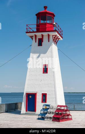 Canada, New Brunswick, Shippagan, lighthouse and lobster pots in the colours of Acadia, blue, white, red and yellow star Stock Photo