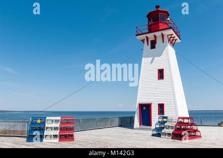Canada, New Brunswick, Shippagan, lighthouse and lobster pots in the colours of Acadia, blue, white, red and yellow star Stock Photo