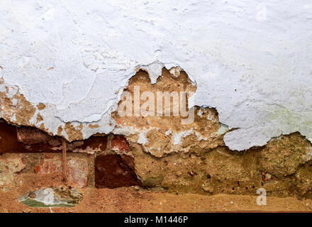 background red brick wall texture with peeling and sprinkle shabby old plaster Stock Photo