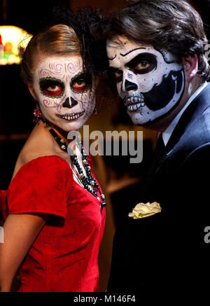 A man and woman dressed in traditional Day of the Dead makeup. Stock Photo