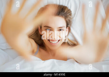 Woman smile in camera, on bed, beauty Stock Photo
