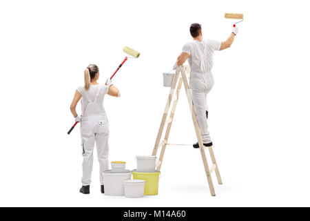 Female painter and a male painter climbed up a ladder painting isolated on white background Stock Photo