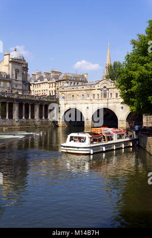 Bath, UK - 3rd July 2011: A trip boat full of sightseers near historic Pulteney Bridge on the River Avon, Bath, UK. Bath is a UNESCO World Heritage Site famous for it's architecture. Stock Photo