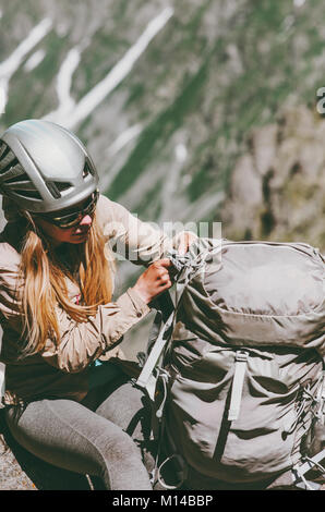 Woman climber with backpack in mountains Travel Lifestyle adventure concept active vacations outdoor gear sport Stock Photo