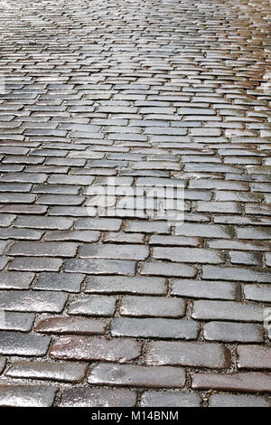 Wet vintage cobblestone road vertical view Stock Photo - Alamy