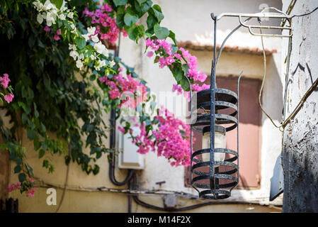 Old vintage street lamp mounted on wall at street of Rhodes town, Greece Stock Photo
