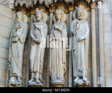 Paris, France: Sculptures of kings, queens and priests on the Portal of  St. Anne on the western facade, southern tower, of Notre Dame Cathedral. Stock Photo