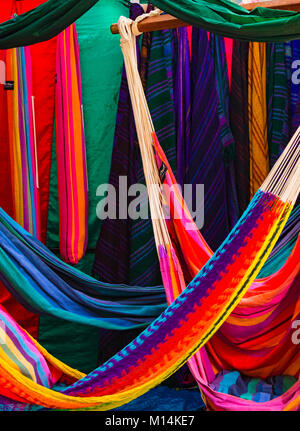 Rainbow colored fabrics, hanging in marketplace, woven Stock Photo
