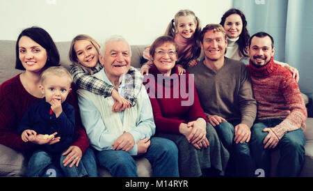 Adults with children are posing for Christmas photos. Stock Photo