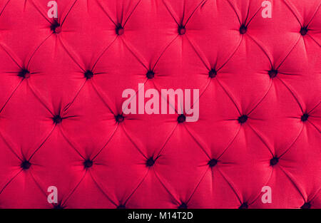 Close up view on bright pink textile texture of sofa Stock Photo