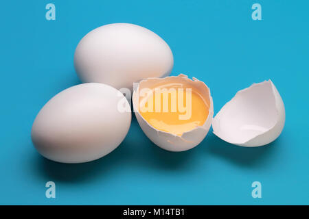 Broken Egg With Yolk Near The Two Whole Eggs Stock Photo
