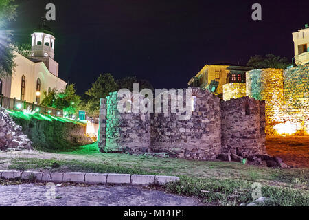 Night photo of Saints Cyril and Methodius church and reconstructed gate part of Sozopol ancient fortifications, Bulgaria Stock Photo