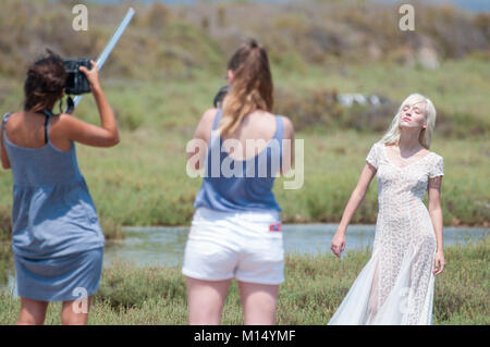 behind the scenes, photographer taking pictures of a model in a white dress, Ebro Delta, Tarragona, Catalonia, Spain Stock Photo
