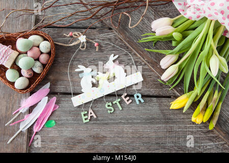 Cheerful decorations for easter on a wooden background Stock Photo
