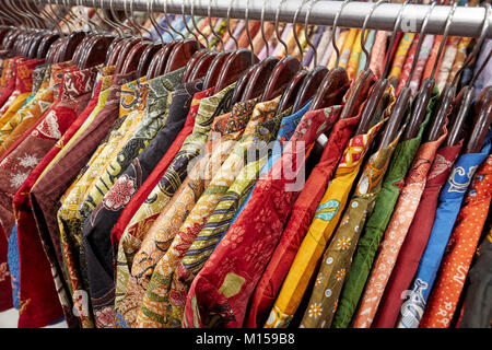 Colorful silk batik shirts on a rack in Hamzah Batik shop. Yogyakarta, Java, Indonesia. Stock Photo