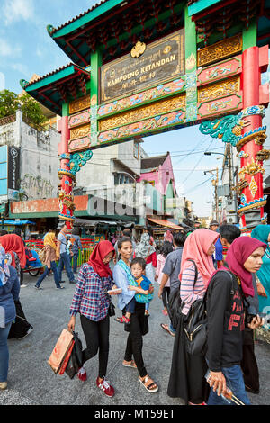 People walking along Malioboro street at the intersection with Kentandan Wetan street. Yogyakarta, Java, Indonesia. Stock Photo